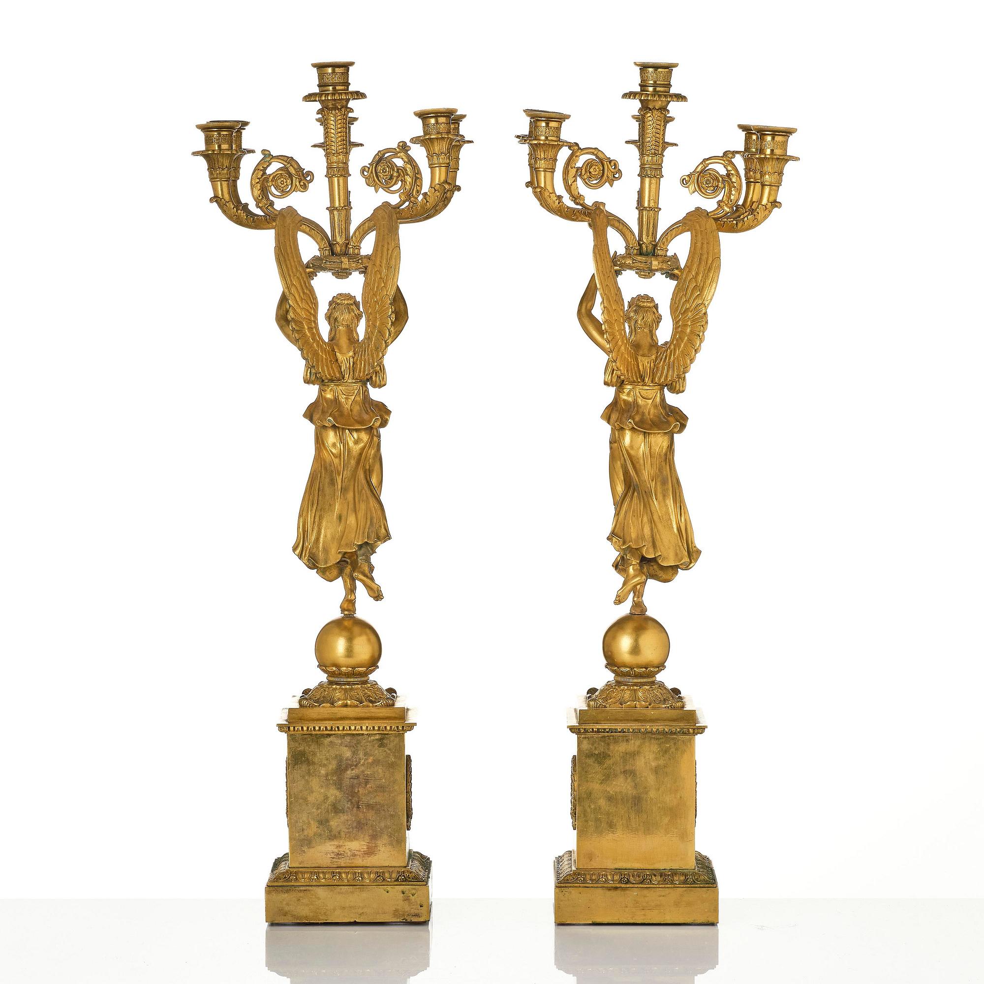A pair of six-branch gilt bronze Empire candelabra, Paris, early 19th century.
