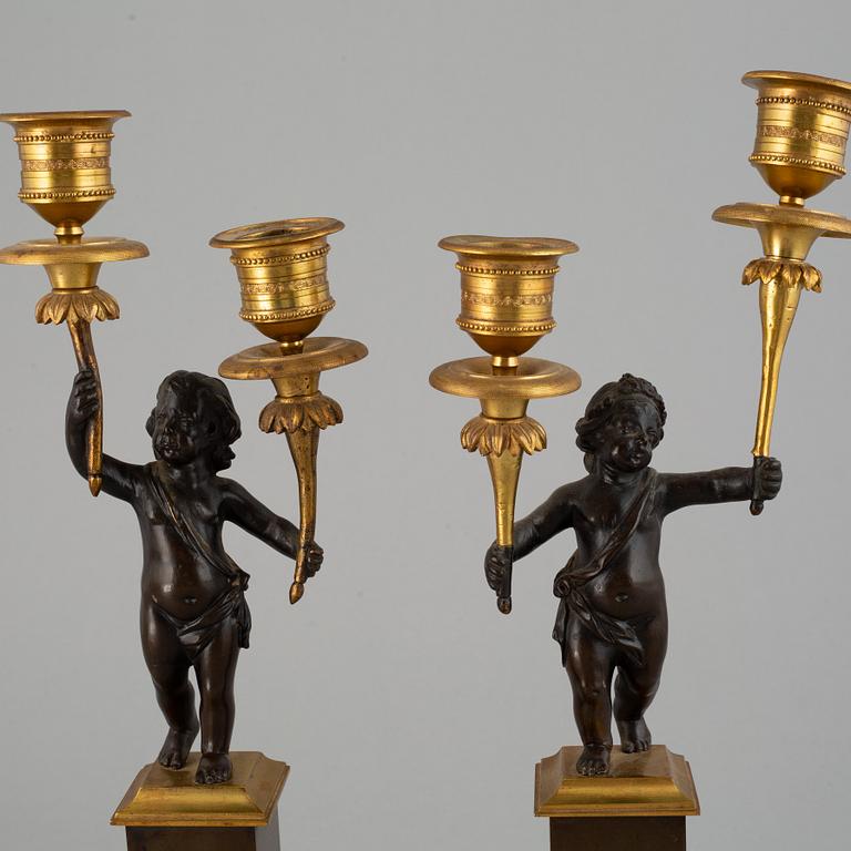A pair of bronze empire style candleabra, 20th century.