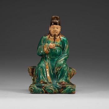 1281. A green and yellow glazed figure of a seated deity, Ming dynasty (1368-1644).