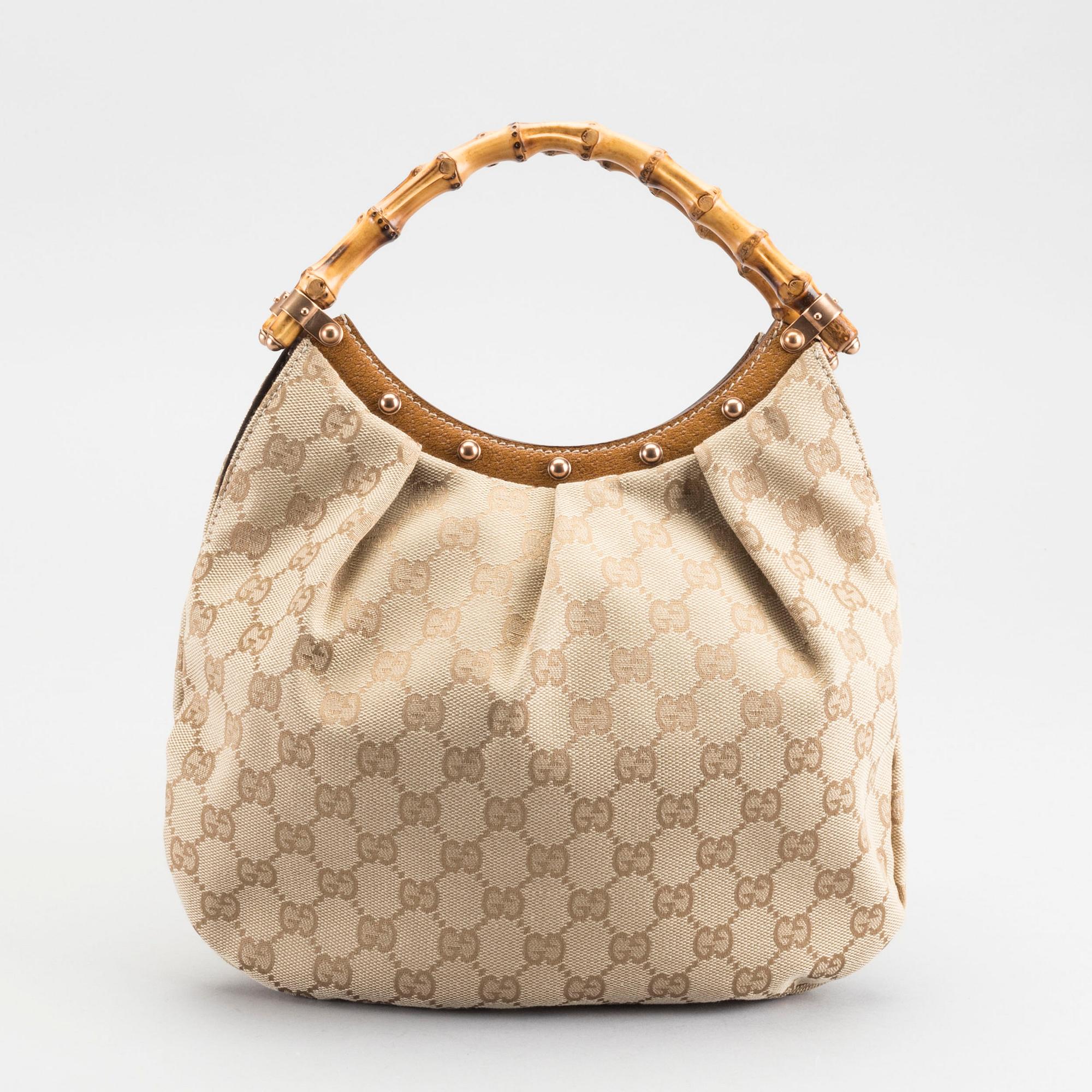 A GUCCI BAG, "STUDDED  BAMBOO HANDLE".