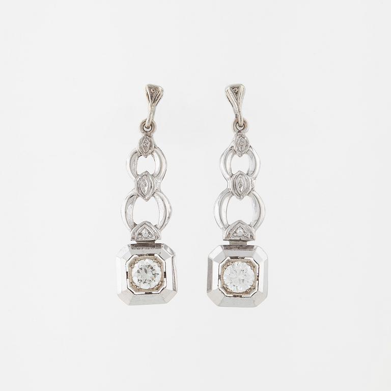 A pair of brilliant cut diamod earrings.