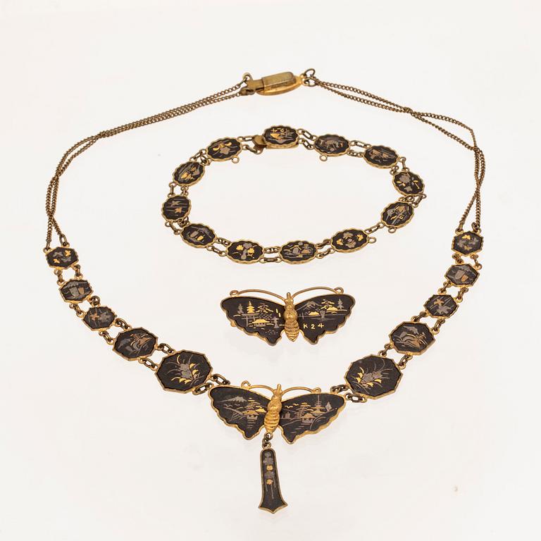 A silver-plated, gilded and lacquered metal parure from Japan, first half of the 20th century.