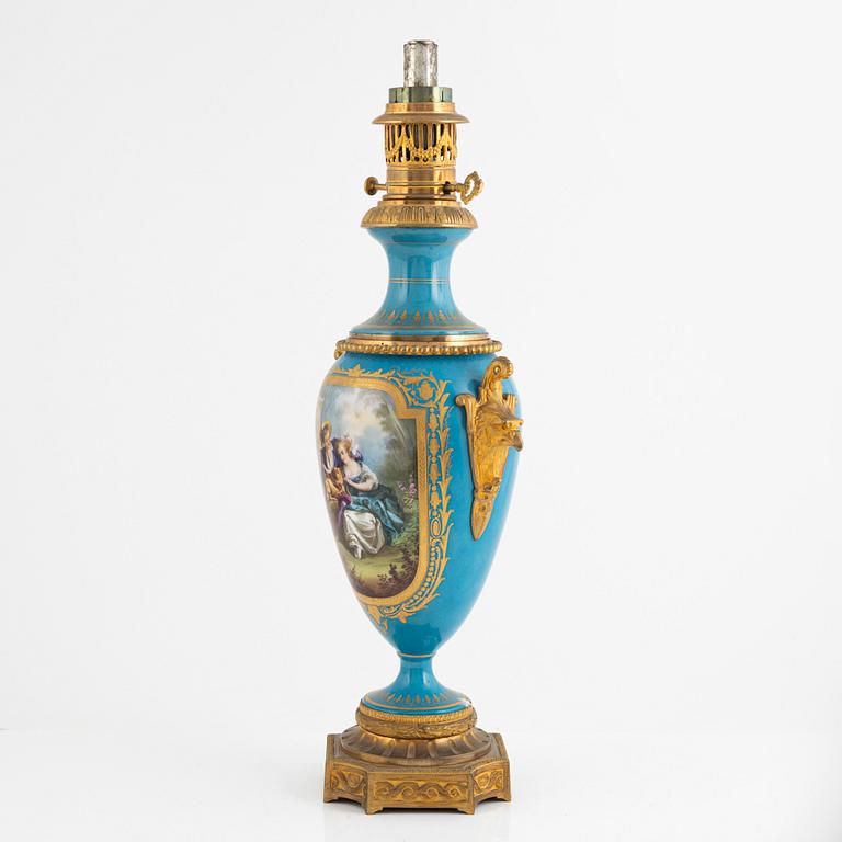 A gilt-brass and porcelaine Louis XVI-style kerosene lamp, later part 19th century.