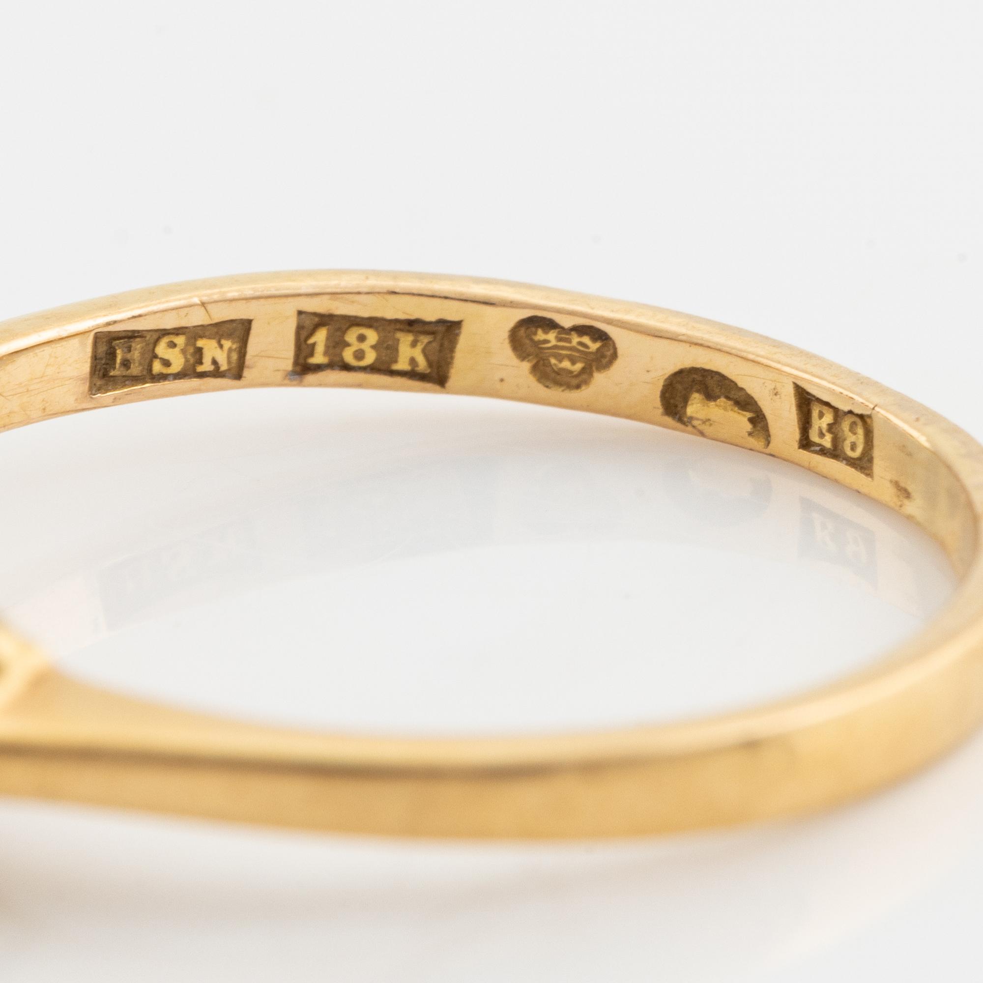 An 18K gold ring set with a sapphire and old-cut diamonds.
