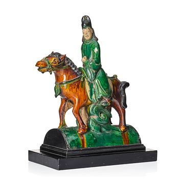 791. A Chinese glazed stoneware ridge tile figure of a mandarin official on a horse, Ming dynasty (1368-1644).