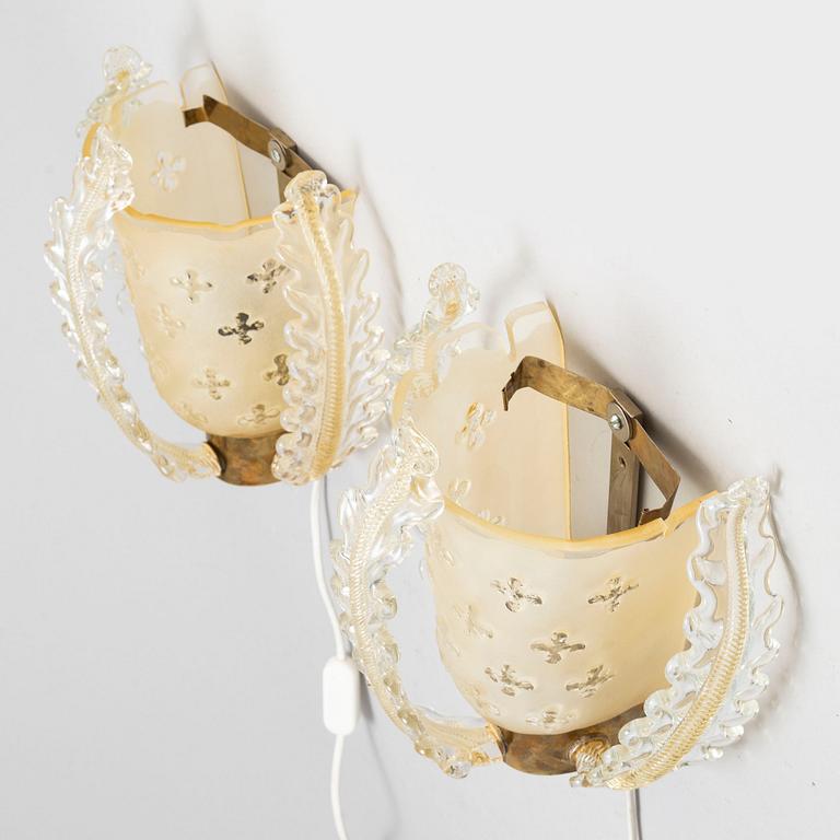 a pair of glass wall lamps from Orrefors in the mid 20th century.