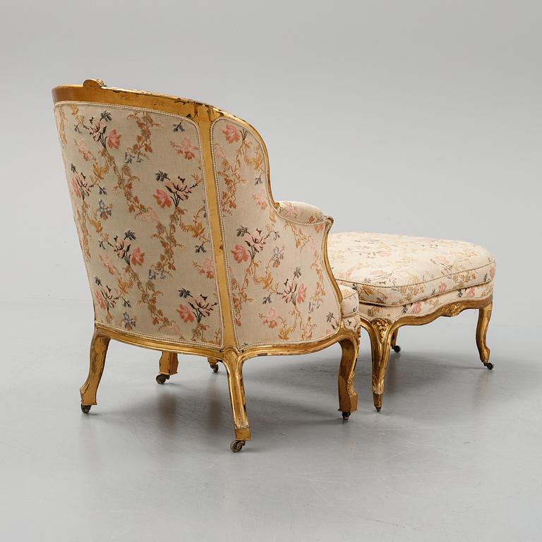 A Louis XV-style bergère armchair with stool, second half of the 19th century.