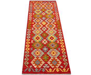 An Afghan kilim runner, c. 301 x 83 cm.
