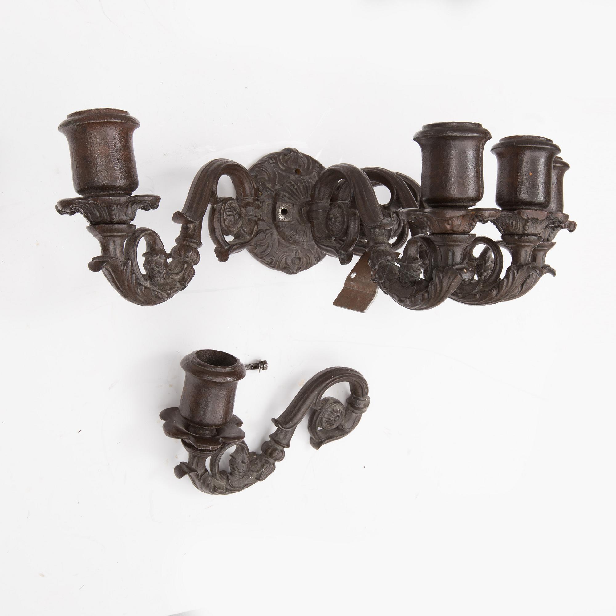 An early 20th century cast iron vall sconce candleholder for five candles.