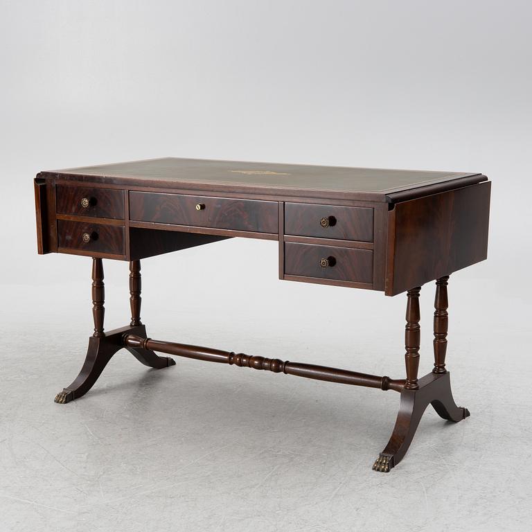 A mahogany veneer desk with desk chair, 20th Century.