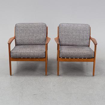 A pair of USA 75, teak lounge chairs by Folke Ohlsson for Dux.