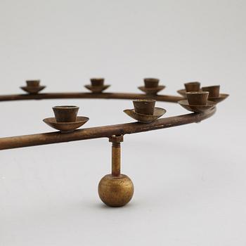 A mid 20th Century brass candle ring.