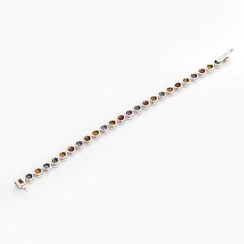 An 18K white gold bracelet, set with multicoloured sapphires.