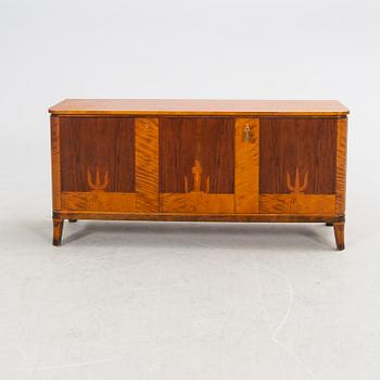 A 1940s walnut, birch and mahogany sideboard.