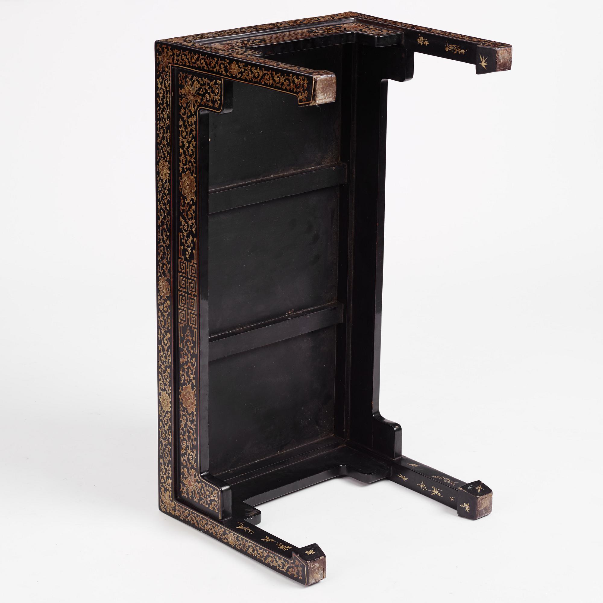 A Chinese black lacquered table with porcelain placques, presumably first half of the 20th century.