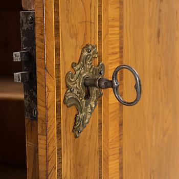 An oak veneered rococo cabinet, mid 18th Century.