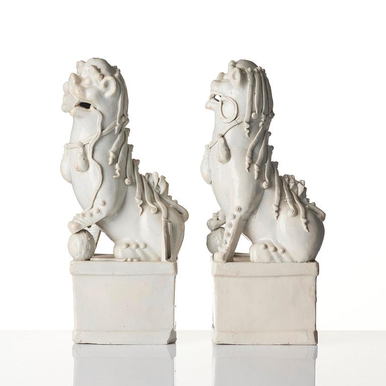 A pair of Chinese blanc de Chine 'Buddhist lion' joss stick holders, Qing dynasty, Kangxi (1662-1722).