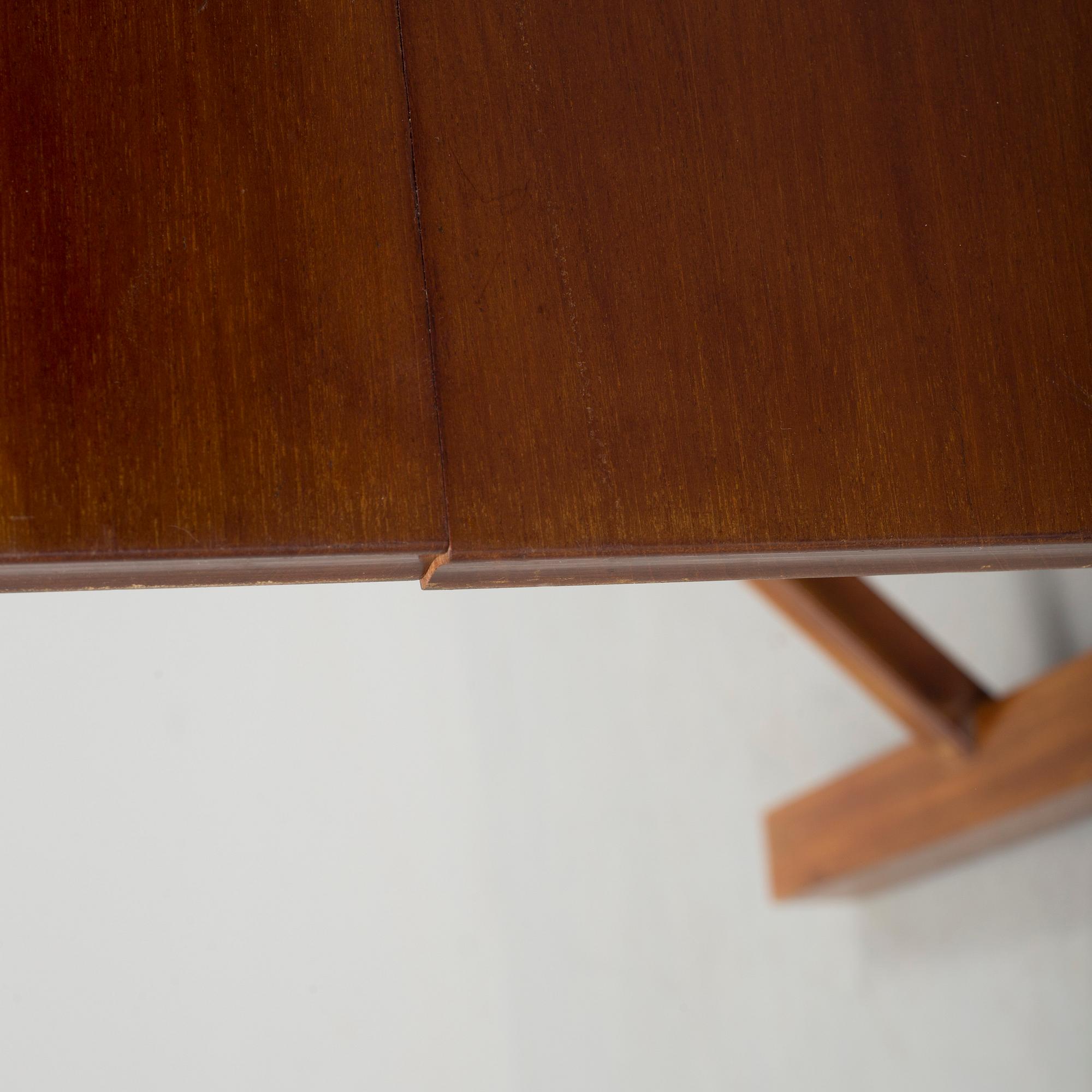 A mid 20th century mahogany veneered table from Nordiska Kompaniet (NK).