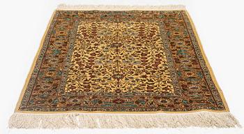 A silk Hereke rug, c. 112 x 74 cm.