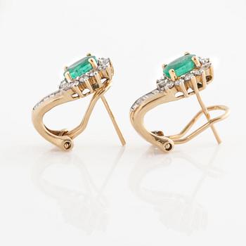 A pair of emerald, baguette and brilliant-cut diamond earrings.