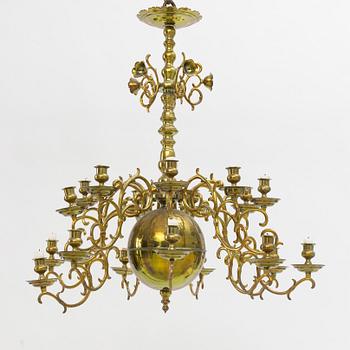 A baroque-style eighteen-branch brass chandelier, late 19th century.