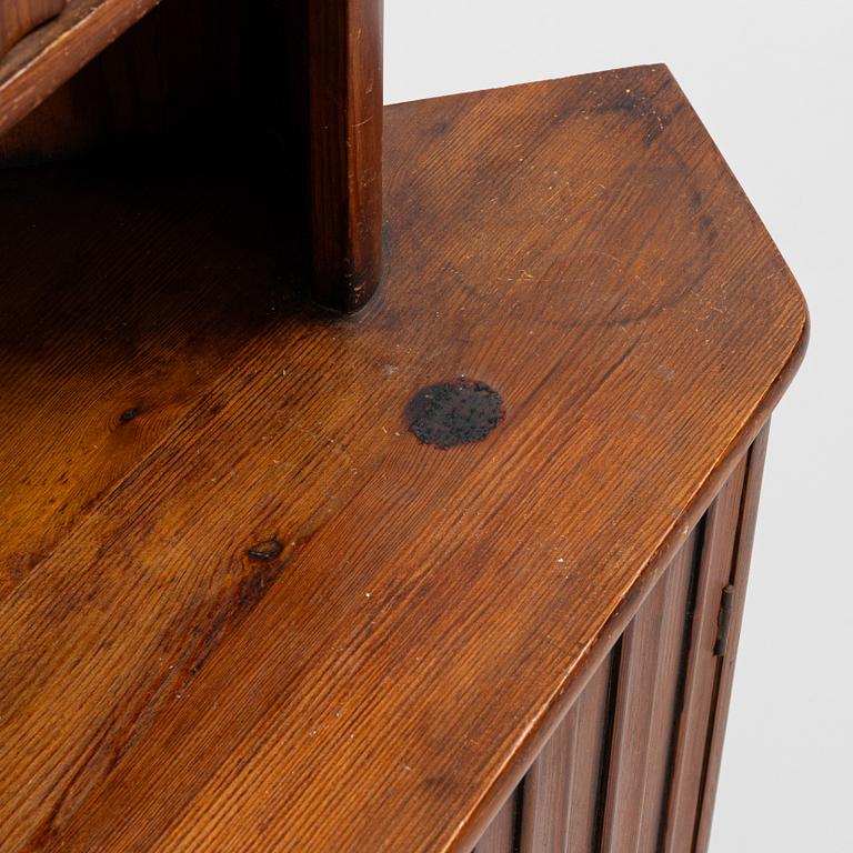 A stained pine corner cabinet, second half of the 20th century.