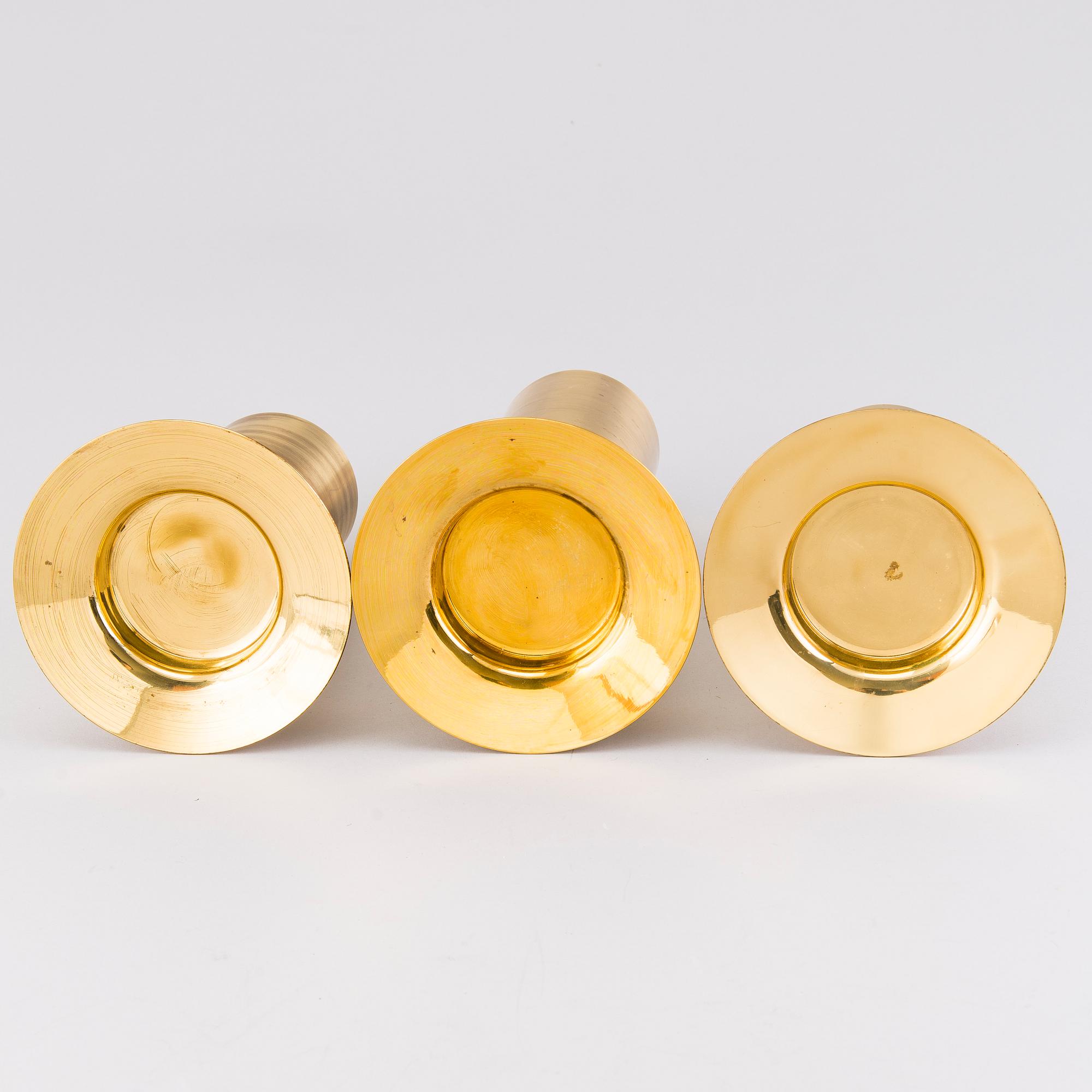 TAPIO WIRKKALA, A set of three brass candleholders, all marked Kultakeskus Oy Made in Finland, Design Tapio Wirkkala.