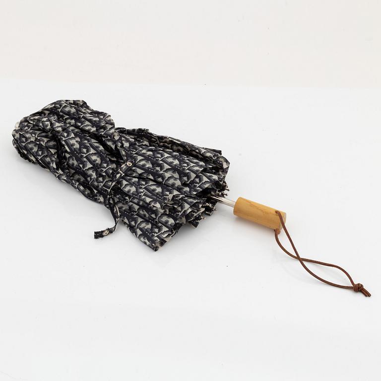 Christian Dior, a black canvas umbrella, toilet bag, coin purse and wallet.