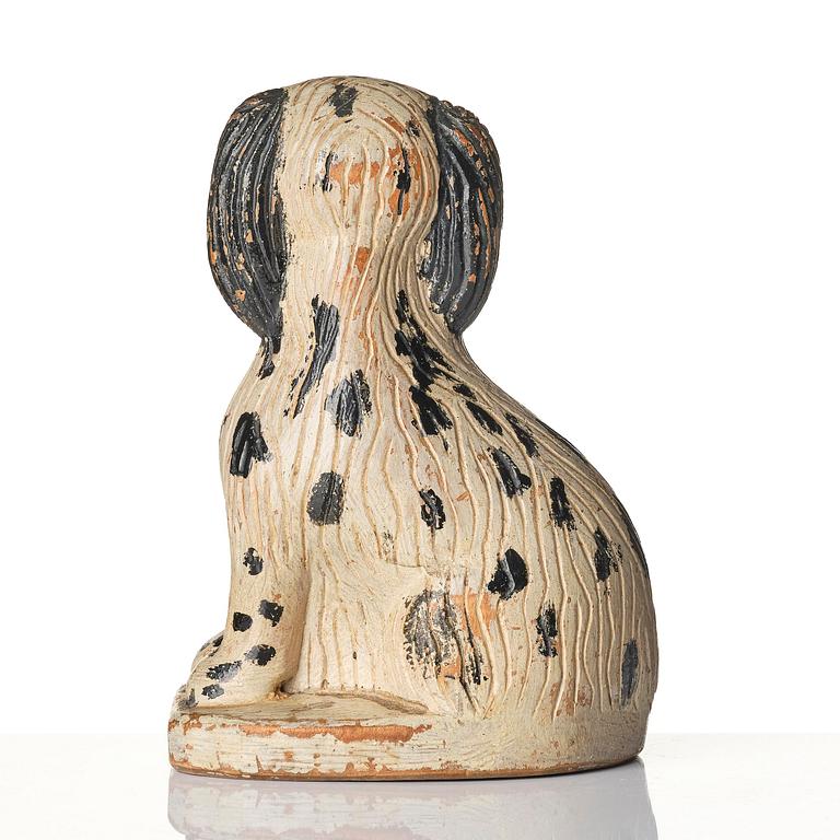 A Swedish wooden folk-art sculpture depicting a 'Staffordshire dog' ceramic figurine, 19th century.