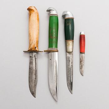 A set of four puukko knives and leather sheats, marked Olympia Helsinki -52.