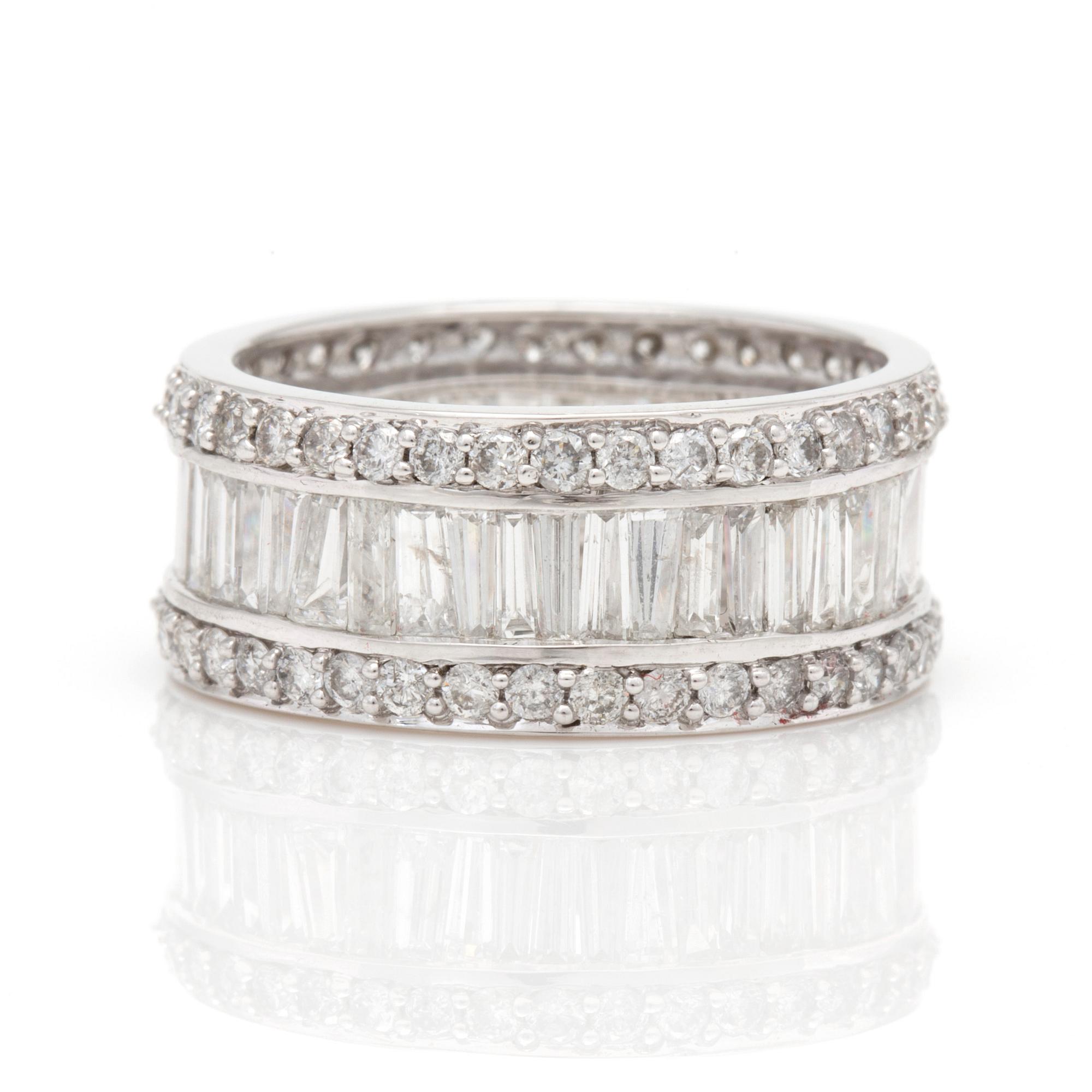 A ring with round, brilliant-cut and tapered, baguette-cut diamonds.