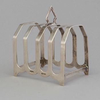 A silver toast rack from J. Gloster Ltd, Birmingham, England, 1933.