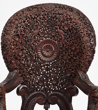 A pair of carved 'blackwood' armchairs, Bombay presidency, British Raj, circa 1880.