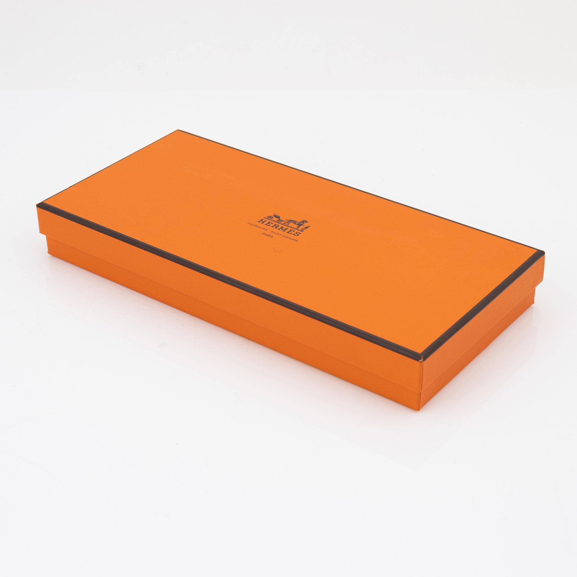 Hermès, a pair of orange kidskin and lambskin gloves, french size 7 1/2.