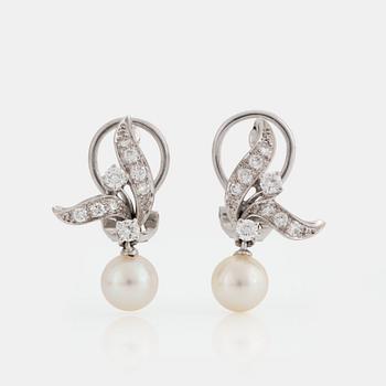 A pair of earrings set with eight- and round brilliant-cut diamonds and cultured pearls.