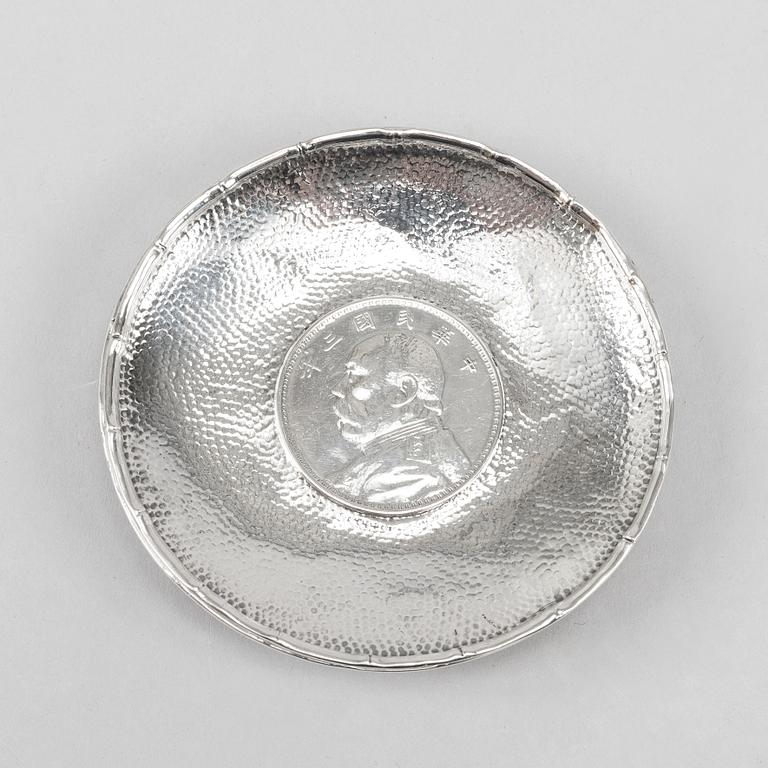 A pair of Chinese silver dishes, with coins, 20th Century.