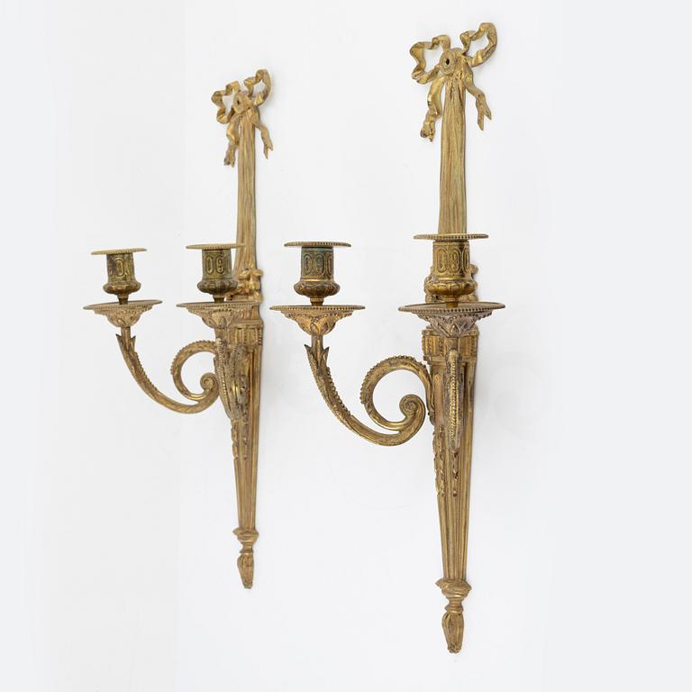 A pair of gilt brass wall sconces, Louis XVI-style, early 20th century.