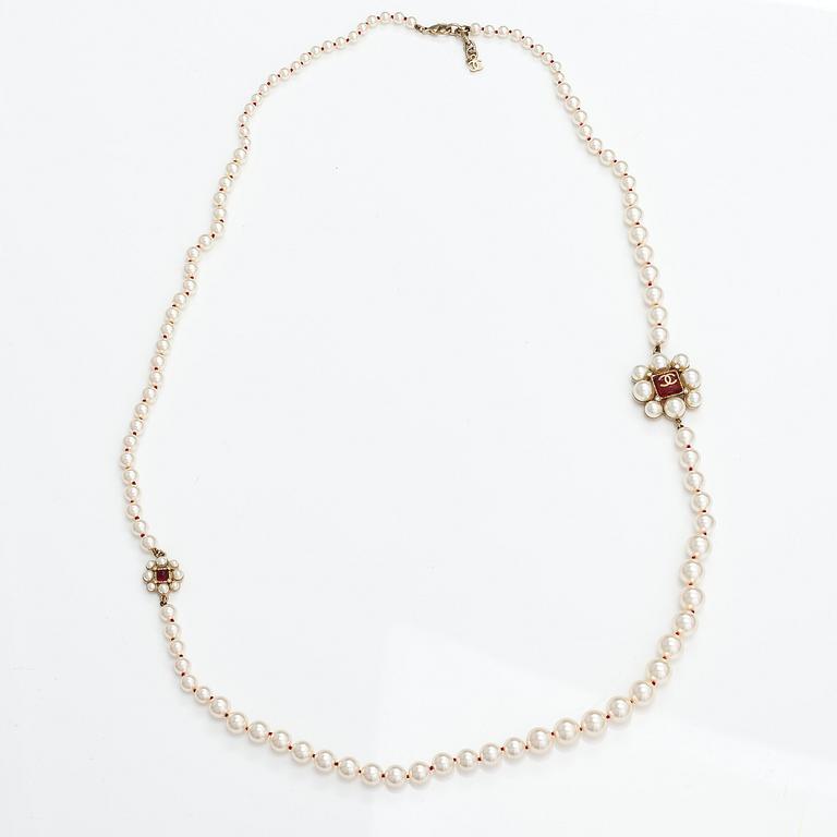 Chanel, A pearl collier with plastic pearls, glass stones and gold coloured metal parts. Marked Chanel, Made in France.