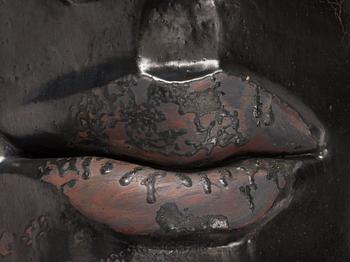 Hertha Hillfon, a black glazed stoneware wall sculpture in two parts of a face and a sky, executed in her own studio, Stockholm 1960s.