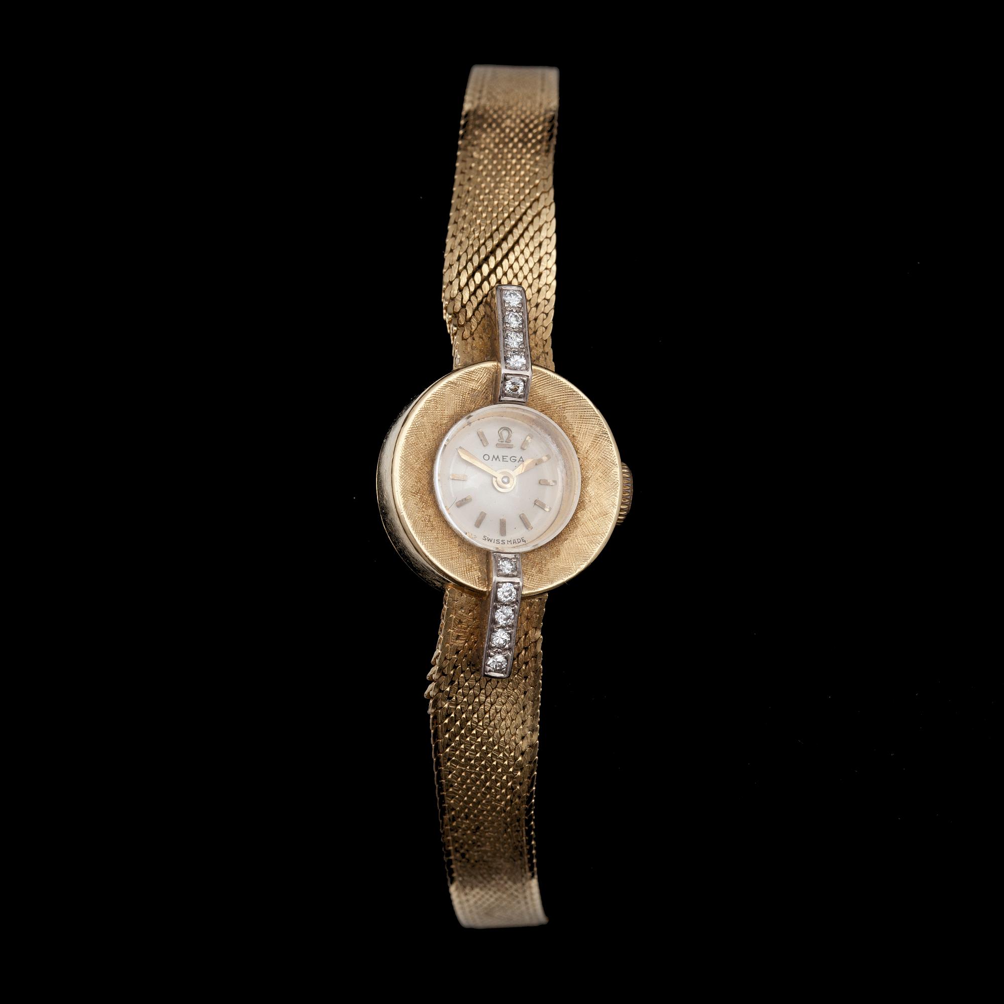 DAMUR, Omega, 18k guld samt små briljantslipade diamanter, 1900-talets mitt. Vikt ca 23g.