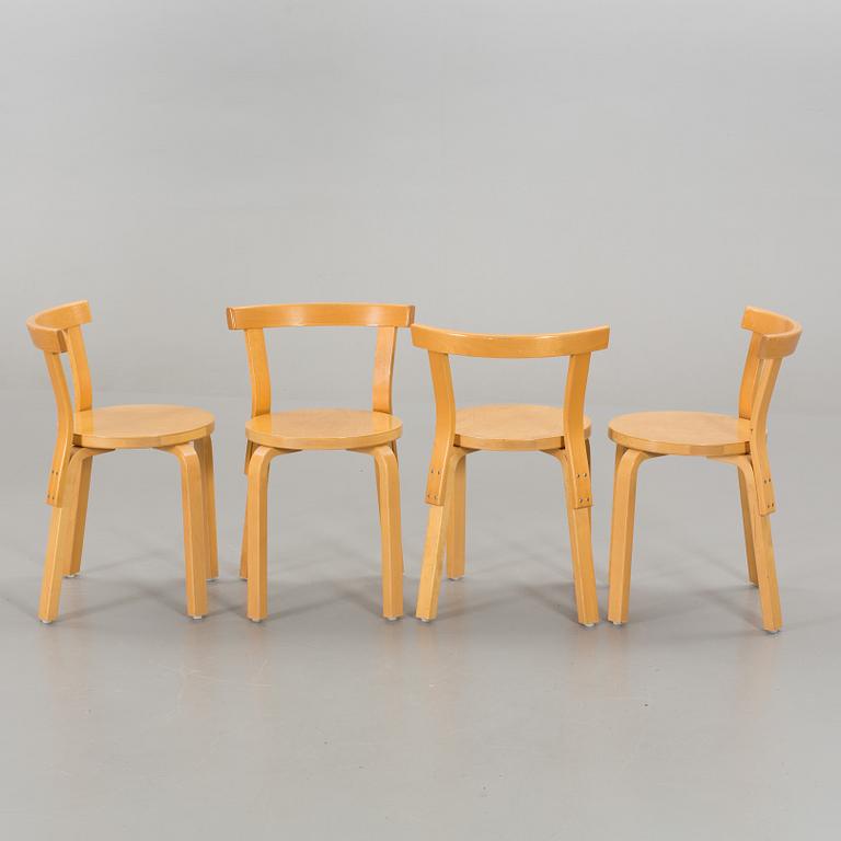 A TABLE AND FOUR CHAIRS DESIGNED BY ALVAR AALTO FOR ARTEK.