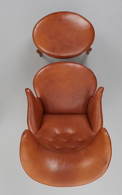 Frits Henningsen, an oak highback chair and ottoman, Denmark 1940's.