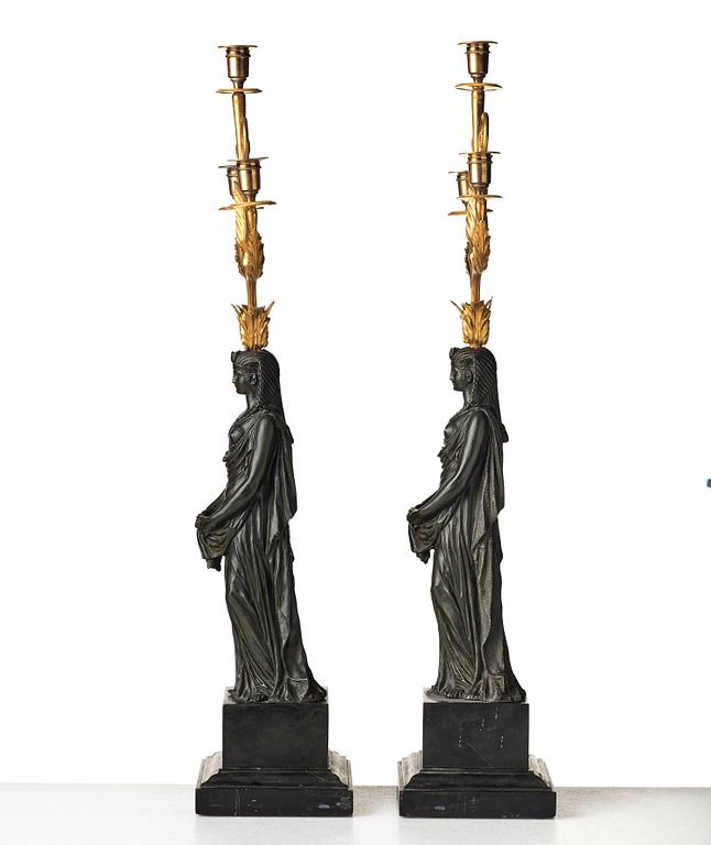 A pair of French Empire early 19th century three-light candelabra.