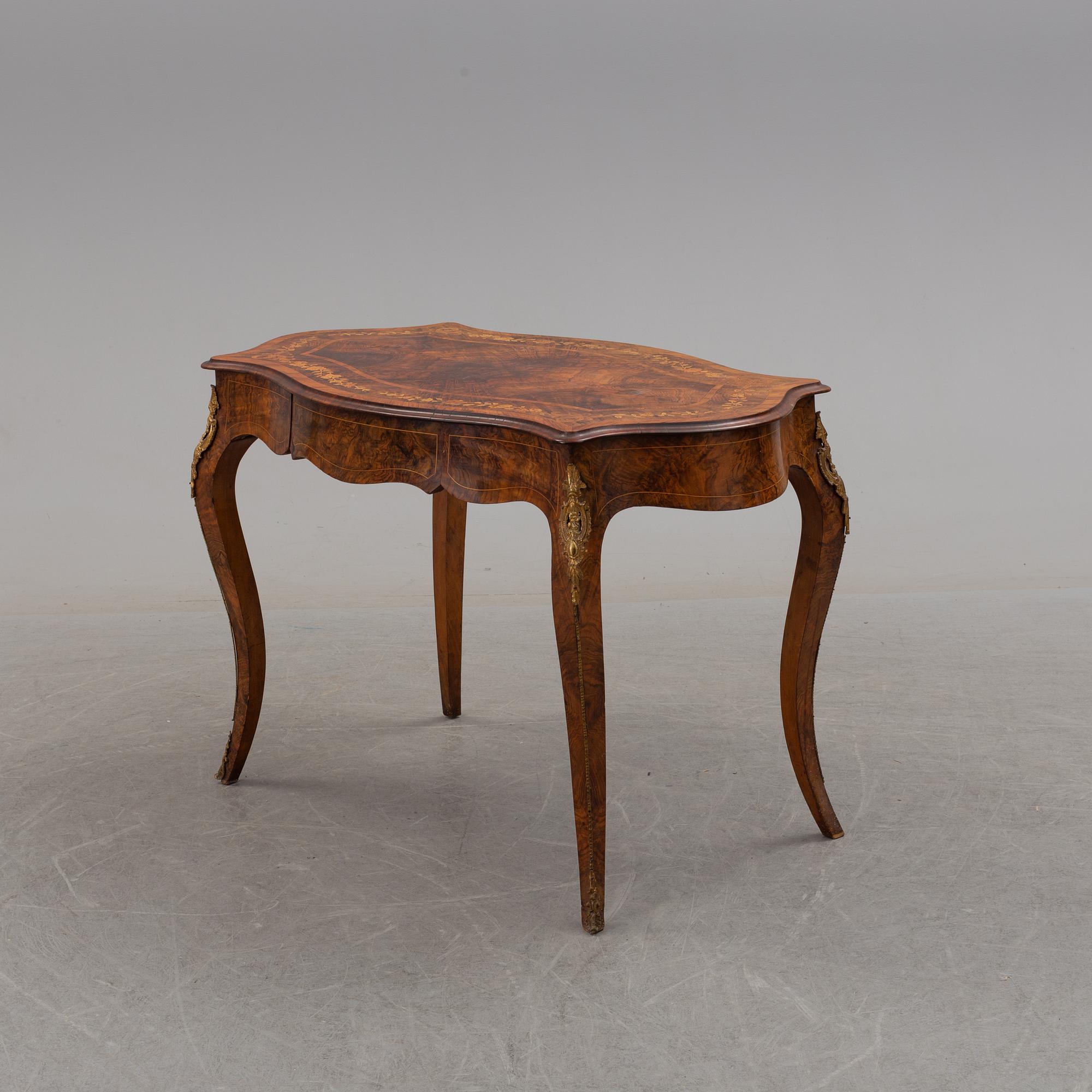 a rococo-style table/desk from England in the late 19th century.