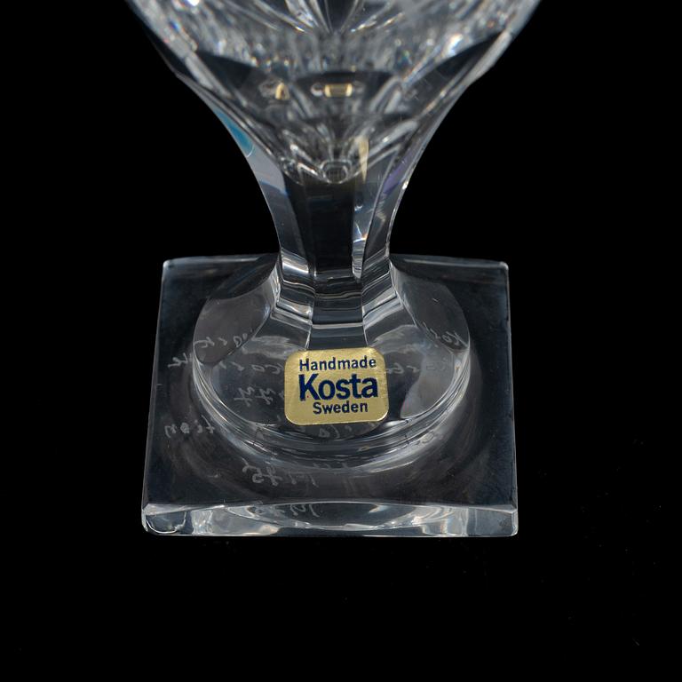 A display cabinet with a 47-piece glass service, "Koskull" from Kosta, Sweden.