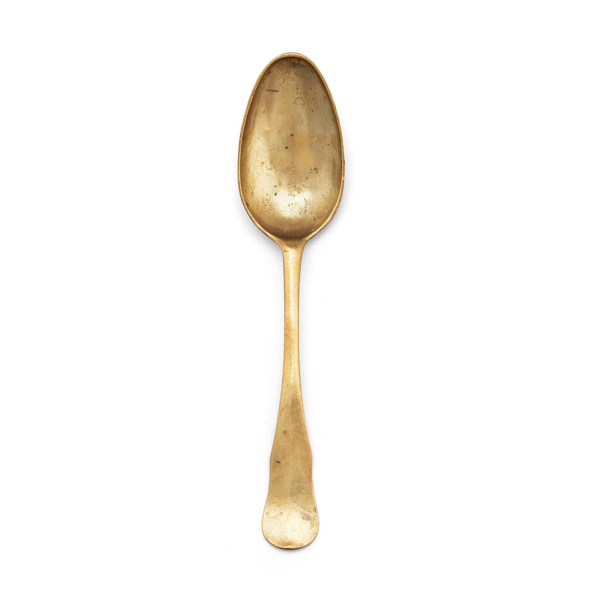 A brass (originally silver plated) spoon by Erik Castman.