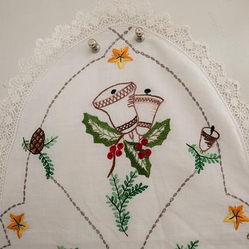 A collection of smaller Christmas tablecloths, runners, and wall hangings, approximately 34 pieces, mid/second half of the 20th century.