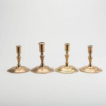 A set of four late Baroque brass candlesticks.