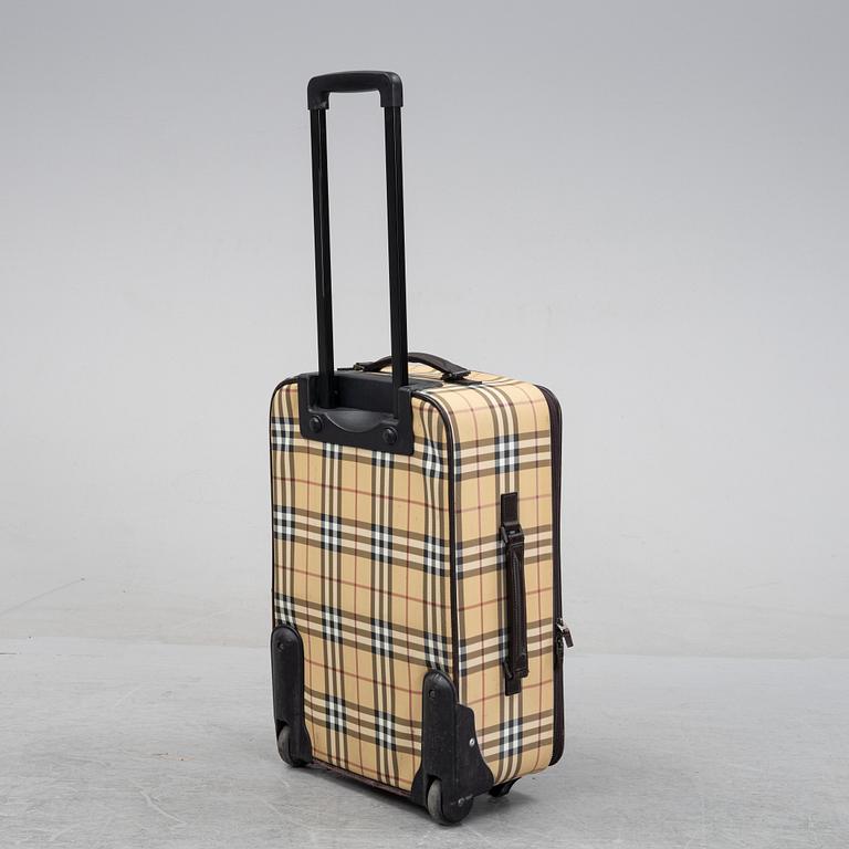Burberry, a Nova Check canvas suitcase.