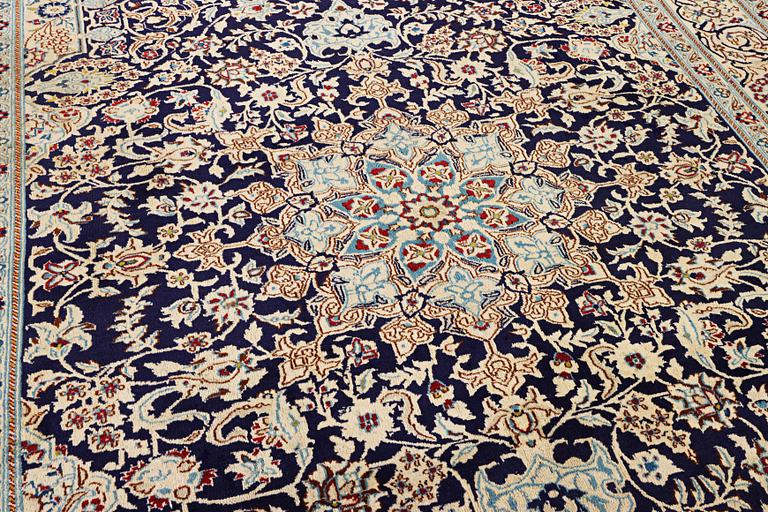 A Nain carpet, part silk, c. 338 x 244 cm.